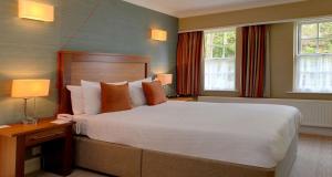 a bedroom with a large bed and two windows at Moore Place Hotel, BW Signature Collection in Milton Keynes +113 photos