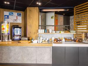 a large kitchen with a counter top and a counter top at ibis budget Angoulême Centre in Angoulême