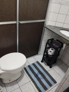a bathroom with a toilet and a sink at Apartamento na praia dos sonhos in Itanhaém +32 photos