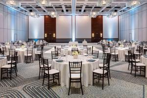 a banquet hall with tables and chairs with white linens at Grand Hyatt Indian Wells Resort & Villas in Indian Wells +219 photos