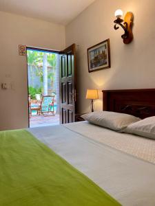 a bedroom with a bed and an open door to a patio at Camali Hotel in Santa Marta