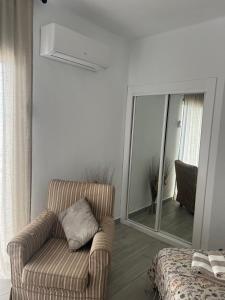 a living room with a chair and a mirror at Paraíso del Encanto in Adeje +16 photos