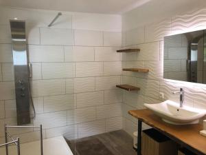 a white bathroom with a sink and a shower at Maison bord de rivière calme jaccuzi in Trooz +20 photos