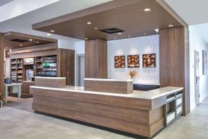 a lobby with a counter in a building at Hilton Garden Inn Dallas Arlington in Arlington