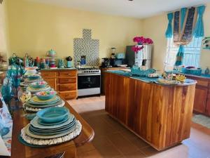 a kitchen with a bunch of plates on a table at Coral Cove Cottage in Negril