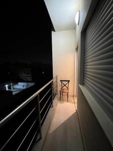 a room with a balcony with a chair and a table at Charmant appartement à Tunis ! in Tunis