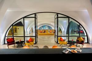 a large window in a room with chairs and tables at DoubleTree by Hilton Sukhumvit Bangkok in Bangkok