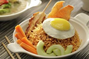 a bowl of rice with an egg and vegetables at DoubleTree by Hilton Gurgaon New Delhi NCR in Gurgaon