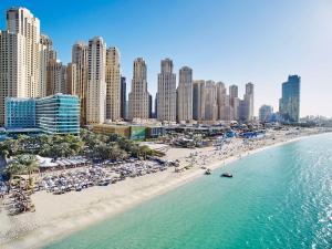 an aerial view of a beach with people and buildings at Hilton Dubai Jumeirah in Dubai +37 photos