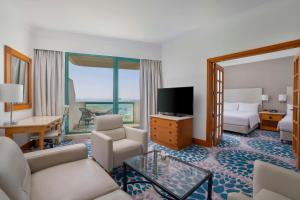 a hotel room with a living room with a living room at Hilton Dubai Jumeirah in Dubai
