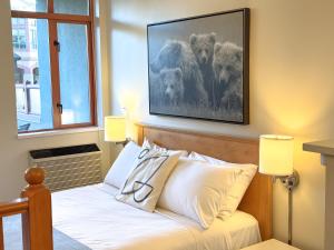 a bedroom with a bed with a picture on the wall at Alpenglow Lodge by MVA in Whistler