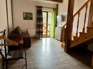 a living room with a staircase and a couch and a television at Край Неба in Slavske +117 photos