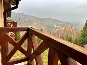 a wooden balcony with a view of a mountain at Край Неба in Slavske