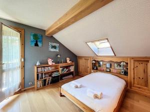a bedroom with a large bed and a skylight at Chalet Les Elfes - Chalet Les Elfes — Luxe et confort pour un séjour MAE-7361 in Les Allues