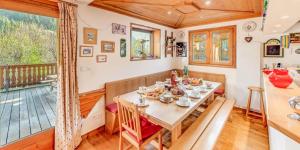 a dining room with a table and a balcony at Chalet Le Prairial - Chalets pour 8 Personnes MAE-0071 in Champagny-en-Vanoise +23 photos