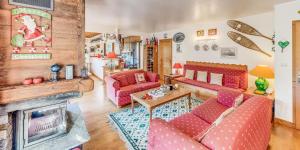 a living room with red furniture and a fireplace at Chalet Le Prairial - Chalets pour 8 Personnes MAE-0071 in Champagny-en-Vanoise