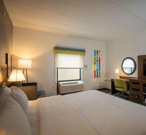 a bedroom with a bed and a desk and a window at Hampton Inn Seaford in Seaford +40 photos