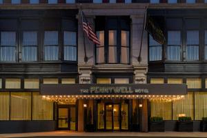 圣路易斯Hilton Pennywell St Louis at the Arch的一座建筑,上面有读到Pennywell酒店的标志