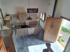 an overhead view of a kitchen with wooden cabinets at LUX CASITA Almendral in Lanjarón