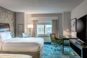 a hotel room with a bed and a desk at Hilton Garden Inn Bethesda Downtown in Bethesda