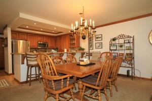 a kitchen with a wooden dining room table and chairs at Mountainback #17, Den in Mammoth Lakes