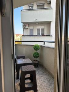a view of a balcony with a table and a plant at Kalman apartman in Bijeljina