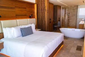 a bedroom with a large bed and a bath tub at Beachfront, Viceroy, San José del Cabo, 5 star in San José del Cabo +24 photos