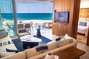 a living room with a couch and a view of the ocean at Beachfront, Viceroy, San José del Cabo, 5 star in San José del Cabo
