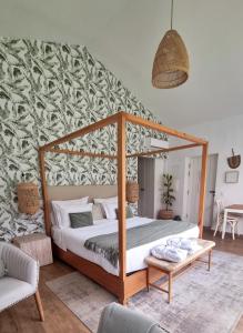 a bedroom with a canopy bed in a room at Quinta das Levadas - Country House & Nature in Alvoco das Várzeas