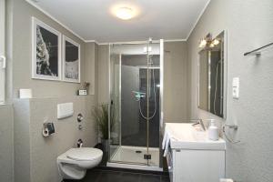 ein Badezimmer mit Dusche, Toilette und Waschbecken in der Unterkunft gratis Nutzung vom AHOI Erlebnisbad und Sauna in Sellin - Kurhaus Nordstrand FeWo 44 in Göhren