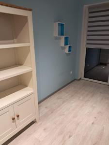 a room with white shelves and a window at VILLA VIP POKOJE pracownicze in Gniezno