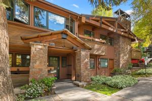a home with a stone and wood exterior at Aspen Condo W Pool, Hot Tub & 2 Blocks To Gondola - Fh4 in Aspen