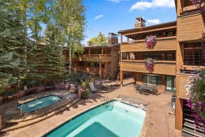 an aerial view of a house with a swimming pool at Aspen Condo W Pool, Hot Tub & 2 Blocks To Gondola - Fh4 in Aspen