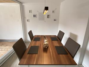 a dining room with a wooden table and chairs at Sky in Überlingen