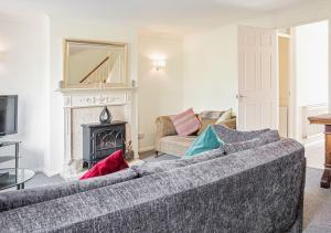 a living room with a couch and a fireplace at Central 2 Bed House w/ Garden and Free Parking! in Cheltenham