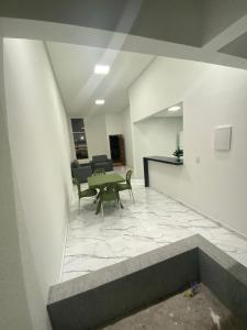 a lobby with a table and chairs in a building at Bela casa jacumã in Conde