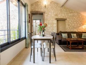 a living room with a table and chairs and a couch at Gites de Saint Maurin in Monjoi