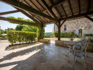 an outdoor patio with a wooden pergola at Gites de Saint Maurin in Monjoi