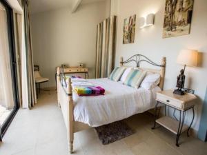a bedroom with a bed and a table with a lamp at Gites de Saint Maurin in Monjoi