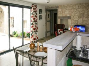 a kitchen with a counter and a table and chairs at Gite La Sempesserre in Monjoi