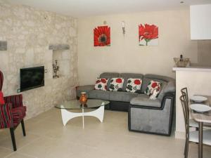 a living room with a couch and a table at Gite La Sempesserre in Monjoi