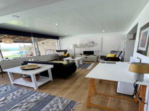 a living room with a couch and a table at Studio in Porto da Cruz with Ocean Views in Porto da Cruz