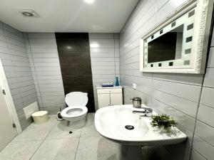 a white bathroom with a toilet and a sink at Holiday home in Porto da Cruz with garden in Porto da Cruz +32 photos