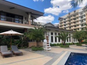 a resort with a swimming pool and a hotel at Mirea Residences Pasig- Two Bedroom Condo Unit with Balcony 70sqm in Manila
