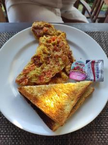 a white plate with two slices of pizza on a table at Lembongan Mantra Huts in Nusa Lembongan