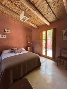 a bedroom with a large bed and a window at La Elegida in Tilcara