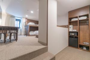 a room with a staircase leading to a bedroom at Hotel Myeongdongjang in Seoul