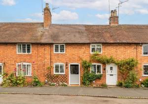 a red brick house with white doors and windows at Poppy Cottage - Cosy 2 Bedroom, Perfect for Family! in Shottery