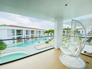 a room with a swing and a swimming pool at Willander Resort in Panglao Island