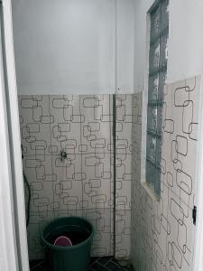 a bathroom with a bucket in the corner of a shower at Princess Villa in Pasirjambu +45 photos